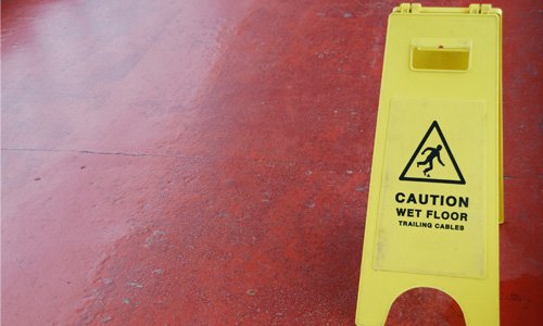 wet floor sign on red tile