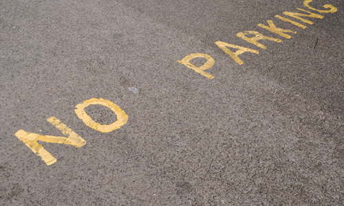 No parking painted on a black top parking lot.